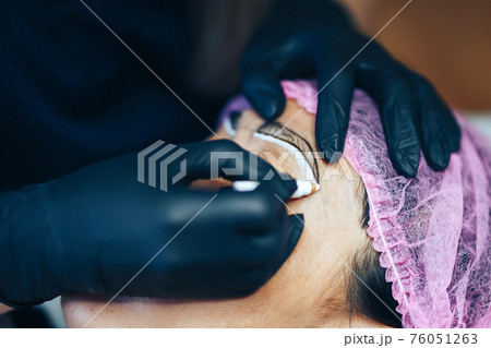 master prepare for Microblading, micropigmentation eyebrows. woman drow on customer eyebrow white pencil, semi-permanent makeup for eyebrows. Focus on eyebrow master prepare for Microblading, micropigmentation eyebrows. woman drow on customer eyebrow white pencil, semi-permanent makeup for eyebrows. Focus on eyebrow 76051263