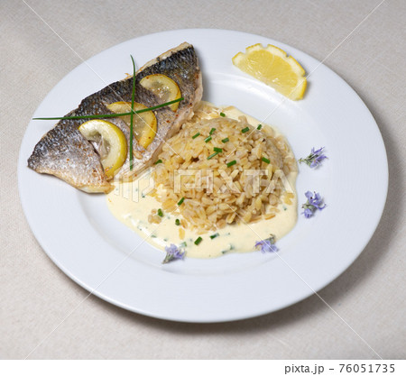 Lemon spiked sea bream fillet, cooked wheat risotto Lemon spiked sea bream fillet, cooked wheat risotto 76051735