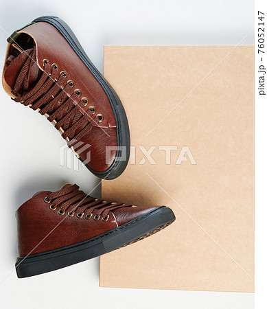 Pair of brown leather shoes on paper box Pair of brown leather shoes on paper box 76052147