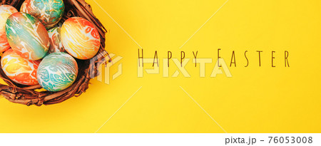 Coloeful easter eggs in nest on yellow color background. Coloeful easter eggs in nest on yellow color background. 76053008