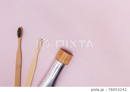 Two wooden bamboo toothbrushes and natural toothpaste 76053242