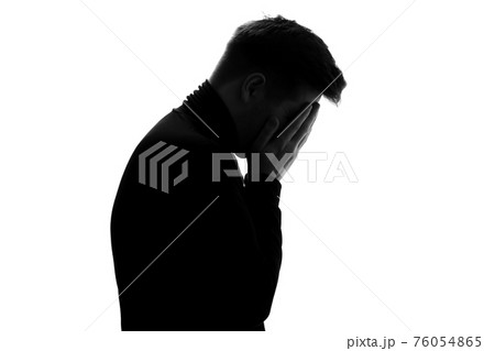 Silhouette of man crying being sad having depression 76054865