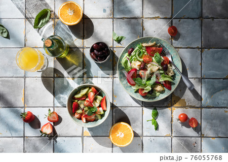 Mediterranean dishes at tiles table: vegetable and fruit salad, lemon and mint lemonade 76055768