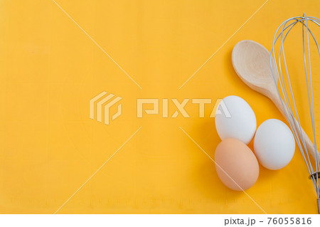 Ingredients for cooking, eggs and kitchen tools on a wooden table top view. 76055816