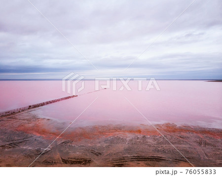 Aerial view of red salt lake. Deserted shoreline without people. Nobody around 76055833