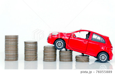 Red miniature car on coin stack : Car loan and leasing time concepts. Car insurance. car model and financial with coins. Red miniature car on coin stack : Car loan and leasing time concepts. Car insurance. car model and financial with coins. 76055889
