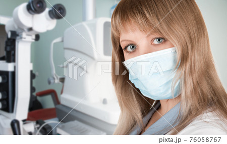 Female ophthalmologist in protective mask Female ophthalmologist in protective mask 76058767