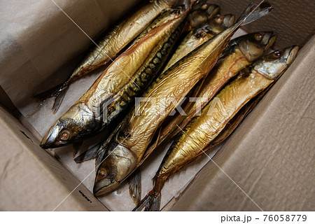 Smoked fish in craft paper box. Smoked fish in craft paper box. 76058779