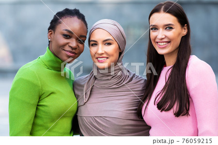 African American, Muslim And Caucasian Ladies Posing Together Standing Outside 76059215