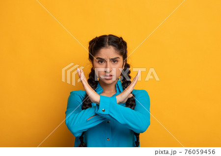 Angry indian woman crossing arms showing stop gesture Angry indian woman crossing arms showing stop gesture 76059456
