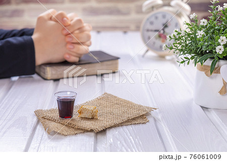 Young woman praying and Taking communion 76061009