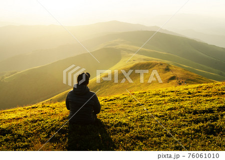 Alone tourist on the edge of the mountain hill 76061010