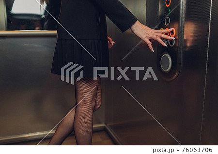 Closeup portrait of a female finger pushing elevator button. Closeup portrait of a female finger pushing elevator button. 76063706