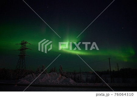 northern light on the silent field before sun rise. northern light on the silent field before sun rise. 76064310