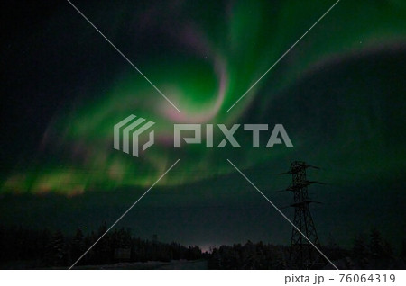 northern light on the silent field before sun rise. 76064319