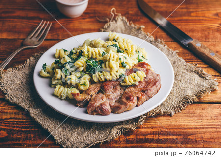 Pork Steak and Creamy Pasta with Spinach 76064742