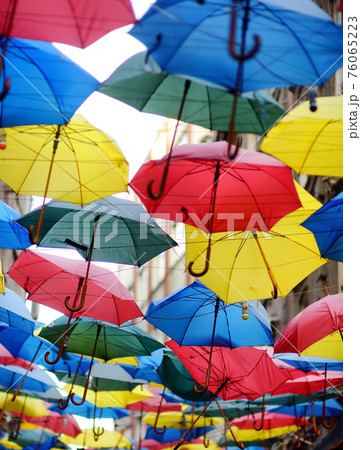 Colorful umbrellas hanging over narrow street of old town, Istanbul, Turkey. Urban street decor. Travel and sightseeing spots in Asia. 76065223