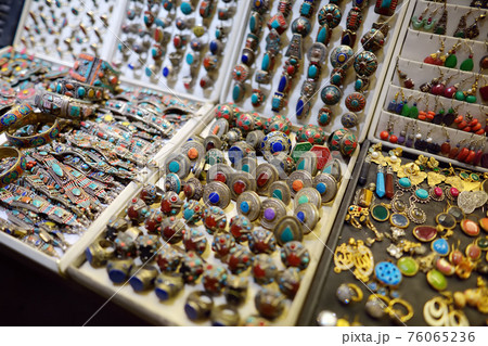 Showcase for sales of jewelry and bijouterie on Istanbul grand bazaar marketplace. Rings, earrings, bracelets and other - traditional gifts from travels by Turkey. 76065236