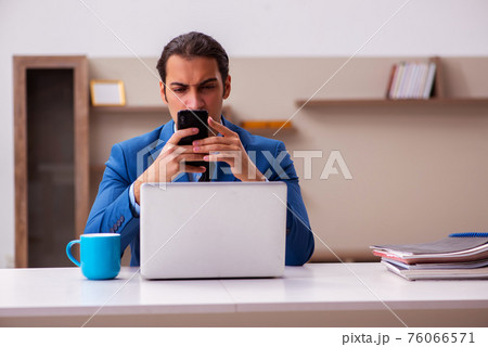 Young male employee working from home during pandemic Young male employee working from home during pandemic 76066571