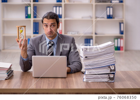 Young male employee in time management concept 76068350