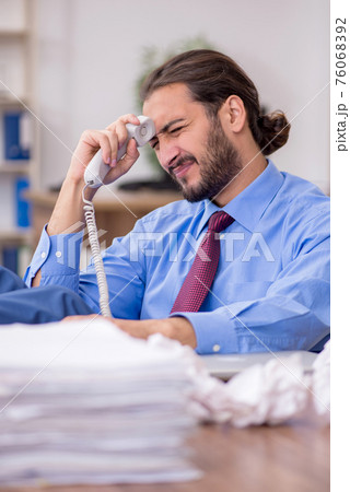 Young male employee in brainstorming concept Young male employee in brainstorming concept 76068392