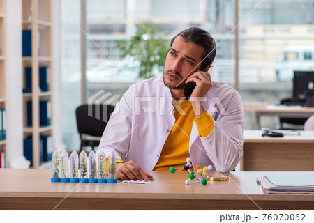 Young male chemist in drug synthesis concept 76070052