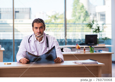 Young male doctor radiologist working in the clinic 76070068