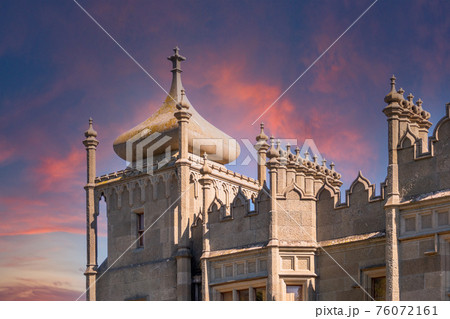 The walls and towers of the old palace on the background of beautiful pink sunset 76072161