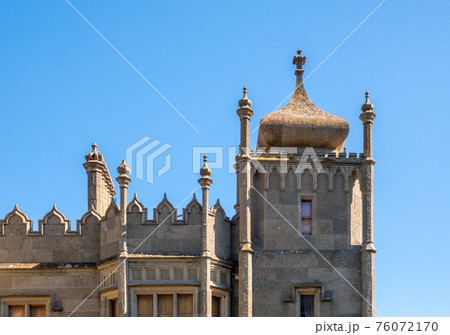 The walls and towers of the old palace on the background of a blue sky The walls and towers of the old palace on the background of a blue sky 76072170