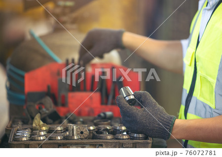 Asian engineer worker quality control of service machine in factory Asian engineer worker quality control of service machine in factory 76072781