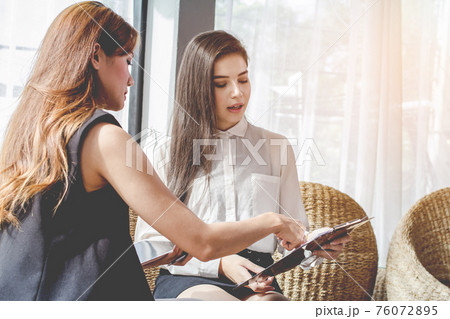 Young Asian. women Business people meeting point to discuss, plan. Young Asian. women Business people meeting point to discuss, plan. 76072895