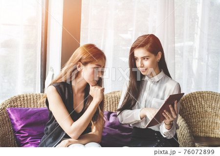 Young Asian. women Business people meeting point to discuss, plan. Young Asian. women Business people meeting point to discuss, plan. 76072899