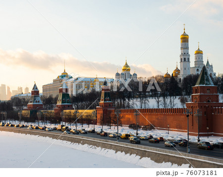 Moscow embankment near Moskva River with Kremlin at sunset in winter 76073181