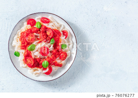 Konjac pasta with tomatoes, low-calorie vegan meal, shot from above Konjac pasta with tomatoes, low-calorie vegan meal, shot from above 76076277