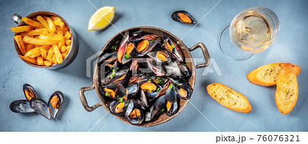 Mussels panorama with wine, fries, and toasts 76076321