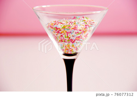 cocktail concept, sweet multicolour candies in martini glass 76077312