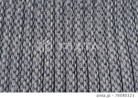 Close-up structure of a knitted product. Scarf, hat or sweater with a chunky knit. Background, texture 76080323