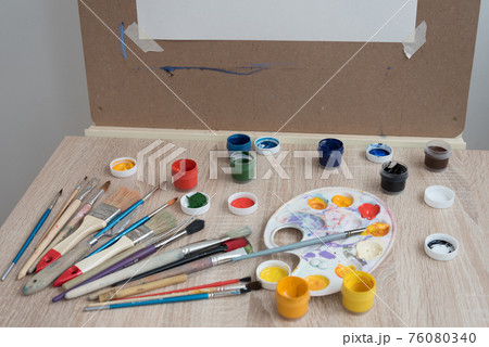 Artist's workplace. Everything is ready for work. Brushes, paints, palette. Blank canvas. Place for text 76080340