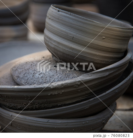 Pottery after firing. Plates and vases, clay from the oven. Background, texture. 76080823