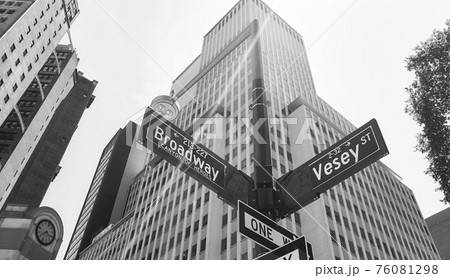 Broadway and Vesey Street signs on a lamp post with lens flare, New York City, USA. 76081298