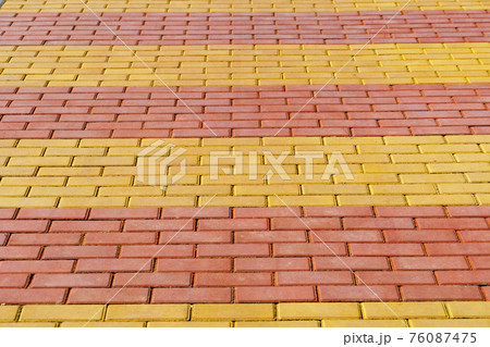 walkway made of paving slabs as a background, bright sunlight 76087475
