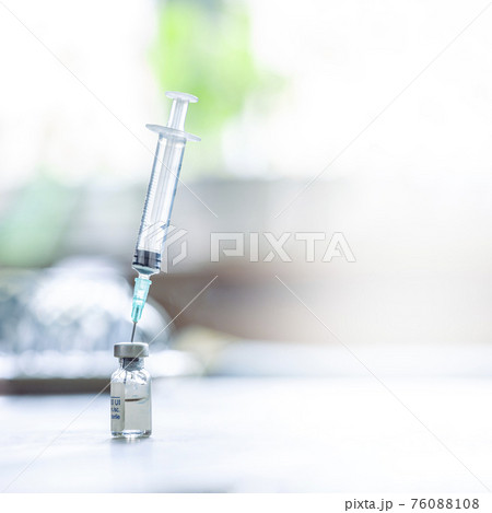 A syringe with the needle in the vaccine vial A syringe with the needle in the vaccine vial 76088108