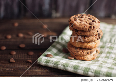 Oatmeal liver lies near the napkin in the box. Rustic table. Vintage toning. Dietary useful cookies without gluten. Copy space. Oatmeal liver lies near the napkin in the box. Rustic table. Vintage toning. Dietary useful cookies without gluten. Copy space. 76088929