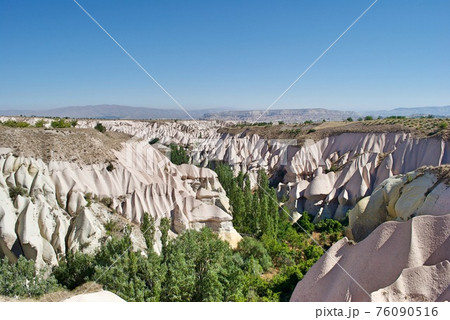 The surrealistic geological landscape formation of Cappadocia, the deposits of volcanoes ash, lava and basalt. Goreme Turkey. UNESCO World Heritage Site. The surrealistic geological landscape formation of Cappadocia, the deposits of volcanoes ash, lava and basalt. Goreme Turkey. UNESCO World Heritage Site. 76090516