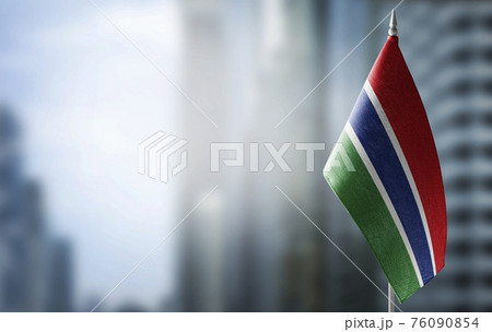 A small flag of Gambia on the background of a blurred background A small flag of Gambia on the background of a blurred background 76090854
