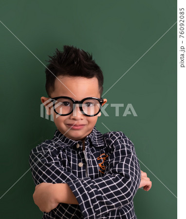 Asian Little boy in casual smile on blackboard. 76092085