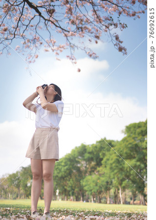 asian woman relax and take photo pink cherry blossom in spring season asian woman relax and take photo pink cherry blossom in spring season 76092615