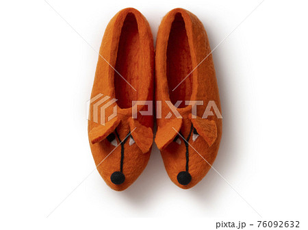 Felt slippers on white background in closeup Felt slippers on white background in closeup 76092632