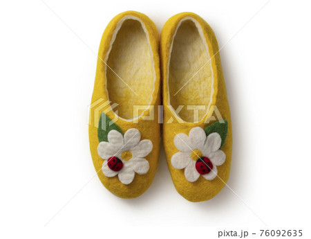 Felt slippers on white background in closeup Felt slippers on white background in closeup 76092635
