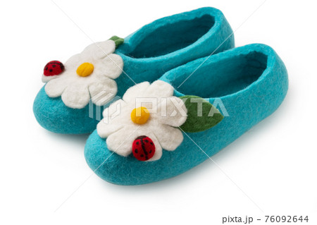 Felt slippers on white background in closeup Felt slippers on white background in closeup 76092644